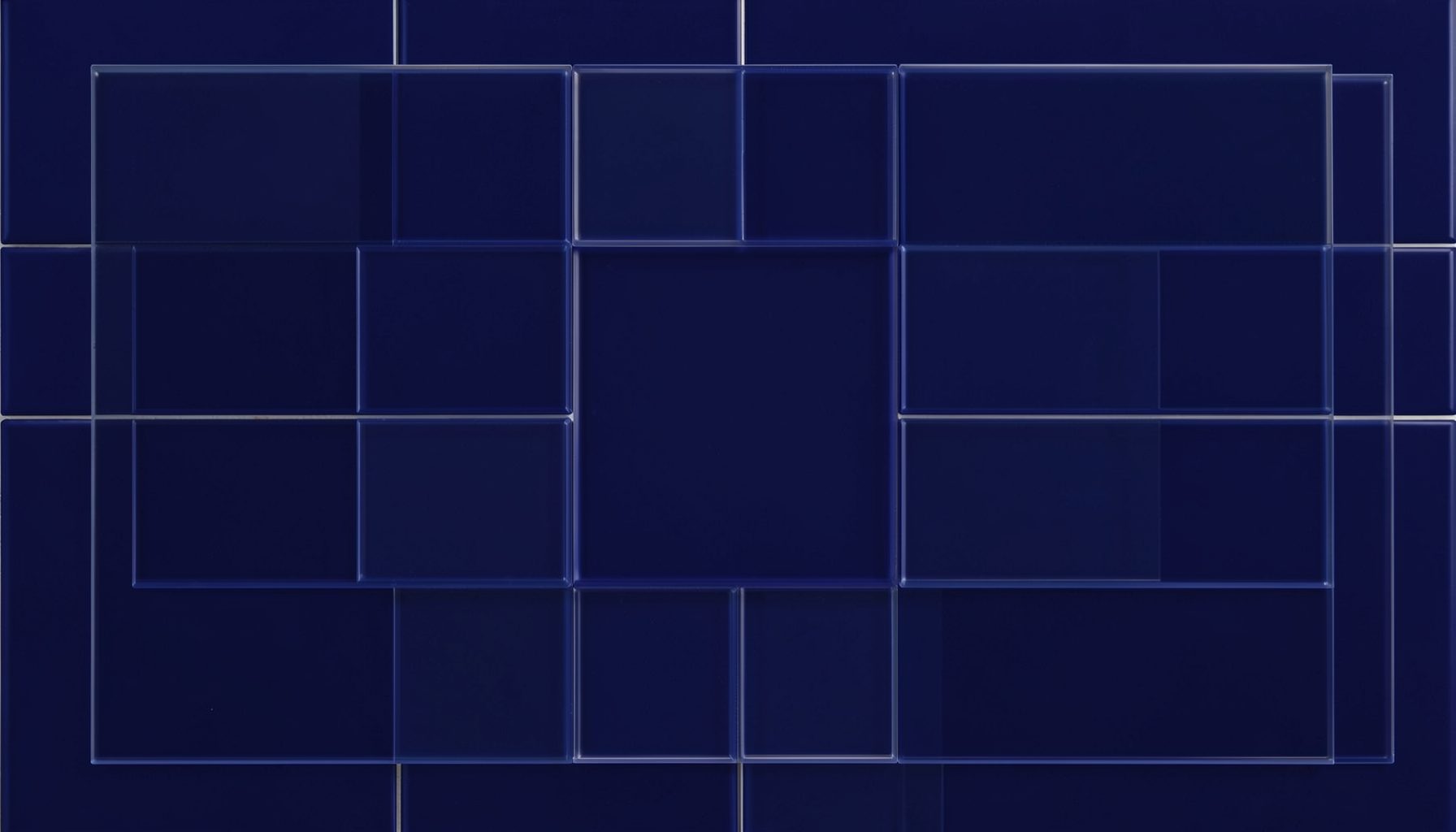 Close-up of glossy dark blue tiles arranged in an overlapping rectangular pattern, deep navy tones, calm and cool mood